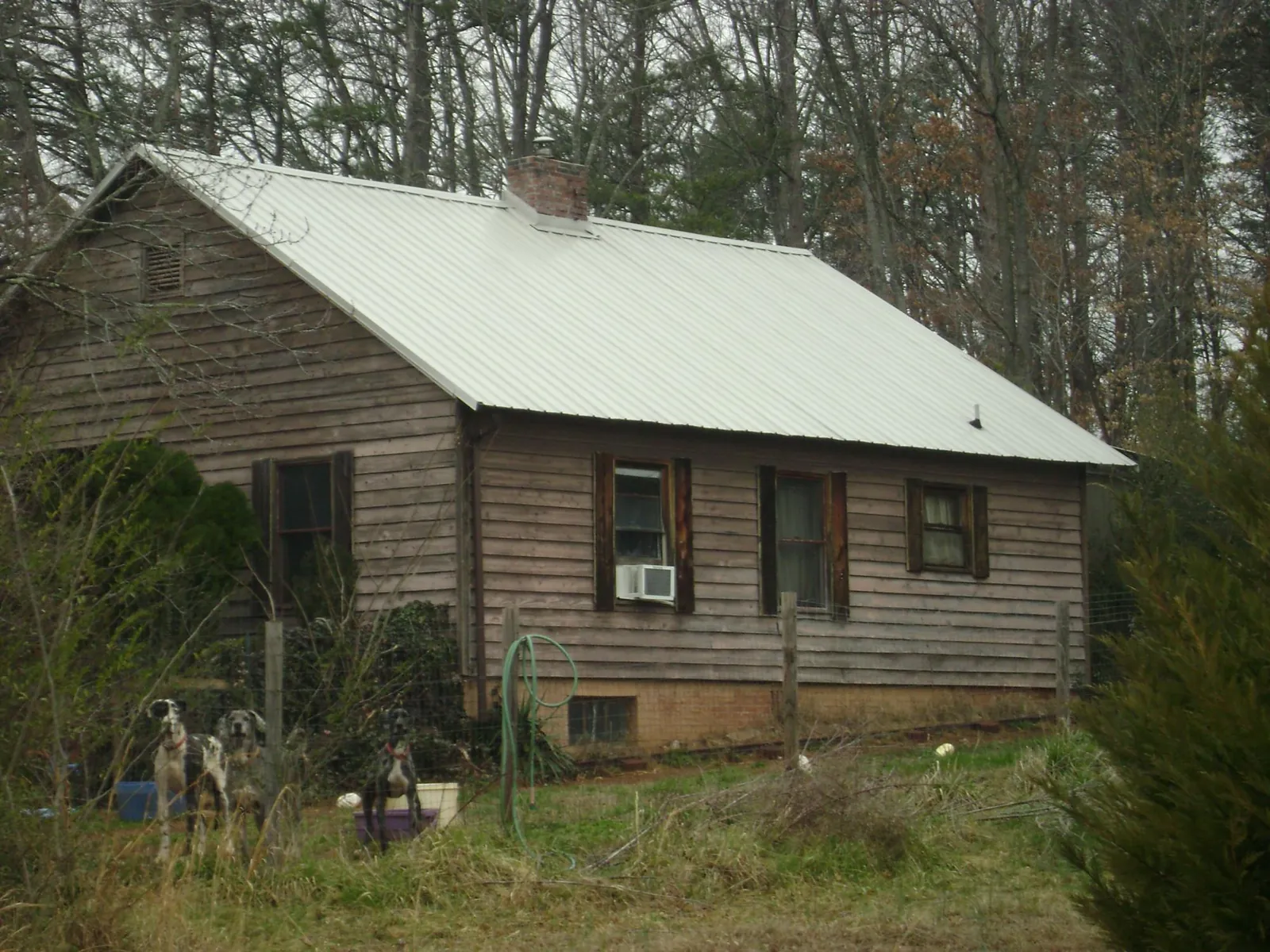 White metal roof on an old wood sided farmhouse, from a Asphalt Shingle Roof Repair job in Waterford Works